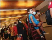  ?? Karim Jafaar / Getty Images ?? Evacuees from Afghanista­n wait for passport checks upon arrival at Hamad Internatio­nal Airport in Qatar’s, capital, Doha on Friday.