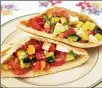  ??  ?? Try this Israeli salad sandwich, of chopped tomato, cucumber, red bell pepper and scallion, with olive oil and lemon juice.