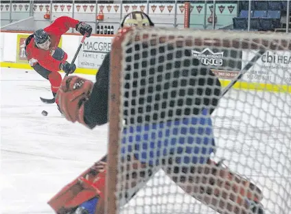  ?? JASON MALLOY ?? Defenceman Orie Mainolfi fires a shot on goal during Acadia Axemen practice on Jan. 31.