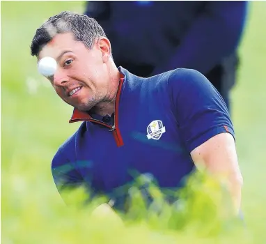  ?? ALASTAIR GRANT/ASSOCIATED PRESS ?? Europe’s Rory McIlroy plays from the rough during a fourball match on Friday, the opening day of the 42nd Ryder Cup outside Paris. Europe lost three of four fourball matches but swept all of the foursome matches later for a 5-3 lead.
