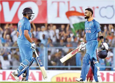  ?? PIC/PTI ?? Virat Kohli celebrates his century with teammate Rohit Sharma during the first ODI against West Indies, at ACA Cricket Stadium, Barsapara in Guwahati, Sunday