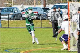  ?? THOMAS NASH — DIGITAL FIRST MEDIA ?? Methacton’s Payton Sikora (2) winds up to take a shot during the first period of Wednesday’s game against Phoenixvil­le.