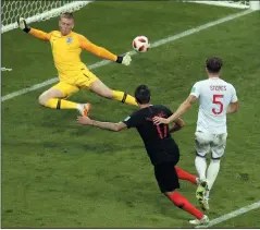  ?? AP PHOTO/ THANASSIS STAVRAKIS ?? Croatia's Mario Mandzukic, second right, scores his side's second goal during the semifinal match between Croatia and England at the World Cup in Moscow, Russia, Wednesday