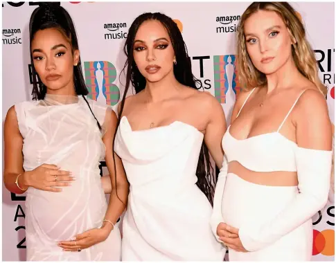  ??  ?? Mix and match: All in white, Leigh-Anne Pinnock and Perrie Edwards cradle bumps either side of Jade Thirlwall