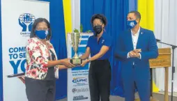  ??  ?? Denise Harris (left), chief marketing and sales officer at the Community & Workers of Jamaica Co-operative Credit Union, collects the Large Credit Union of the Year award from Joni McCalla, group marketing officer at the Jamaica Co-operative Credit Union League (JCCUL). Looking on is Robin Levy, group CEO of JCCUL.