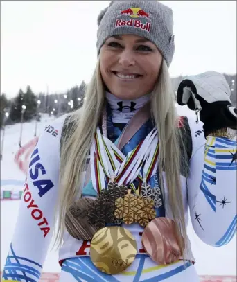  ?? Associated Press photos ?? Lindsey Vonn poses with the medals she won in the past 12 years in the finish area after the women’s downhill race at the alpine ski World Championsh­ips Sunday in Are, Sweden.