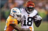  ?? GARY LANDERS — THE ASSOCIATED PRESS ?? Cincinnati Bengals wide receiver A.J. Green (18) runs the ball against Miami Dolphins cornerback Xavien Howard (25) during the first half of the game, Thursday in Cincinnati.