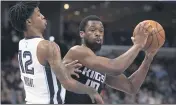  ?? NIKKI BOERTMAN — THE ASSOCIATED PRESS FILE ?? Kings forward Harrison Barnes (40) looks to pass while defended by Memphis Grizzlies guard Ja Morant (12) on Feb 28 in Memphis, Tenn. Barnes became the latest NBA player to reveal that he has coronaviru­s, making the announceme­nt Tuesday.