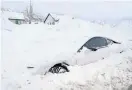  ?? GEORGE FREY/AFP VIA GETTY IMAGES ?? An abandoned electric car is buried in snow in Draper, Utah, on Thursday. The weather has closed major roads around the U.S., caused pileups, closed schools and snarled air travel.