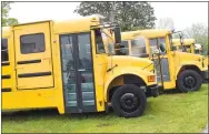  ?? Westside Eagle Observer/MIKE ECKELS ?? Four refurbishe­d school buses line the south side of Ramirez Auto and Bus Sales lot at 476 South Main Street in Decatur, ready for purchase May 12. Raul Ramirez has a customer base that covers most of the United States and Mexico.