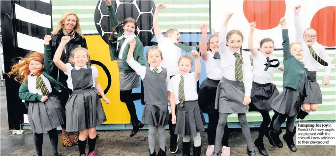  ??  ?? Jumping for joy St Patrick’s Primary pupils are pleased with the colourful new addition to their playground