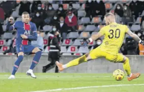  ?? (Photo: AFP) ?? Paris Saint-germain’s French forward Kylian Mbappe (left) scores a goal during the French L1 football match between Nimes and Paris Saint Germain at the Costieres Stadium in Nimes, southern France, yesterday.