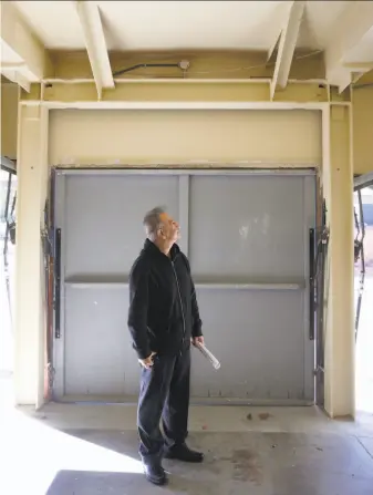  ?? Paul Chinn / The Chronicle ?? Engineer Homy Sikaroudi inspects steel columns and beams at a soft-story apartment building he retrofitte­d in Oakland. Such work may soon be required at many buildings in the city.