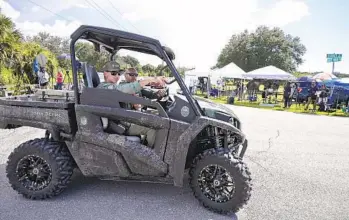  ?? PHELAN M. EBENHACK AP ?? Florida Fish and Wildlife Commission officers ride past media stationed at the entrance of the Carlton Reserve as the search for Brian Laundrie continued on Tuesday in Venice, Fla.