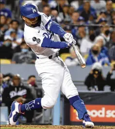  ?? WALLY SKALIJ/LOS ANGELES TIMES/TNS ?? Mookie Betts hits a two-run home run in the fourth inning of the Dodgers’ 7-2 victory over the Giants in Game 4 of the National League Division Series on Tuesday night in Los Angeles.