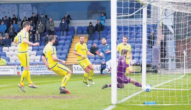  ?? Peter Hilton Photograph­y ?? Chris Holroyd scores Macclesfie­ld’s goal in the 2-1 defeat against Guiseley at the Moss Rose on Saturday