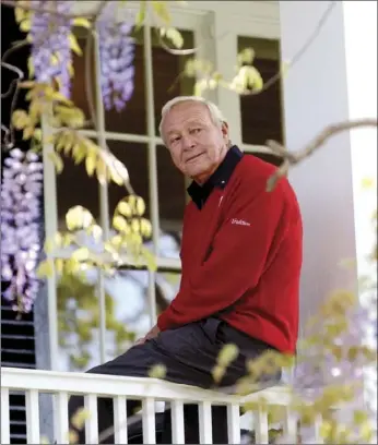  ?? PHOTO ?? This 2004 file photo shows former Masters champion Arnold Palmer as he sits on clubhouse railing at the Augusta National Golf Club in Augusta, Ga. AP