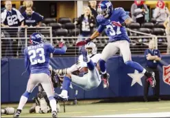  ?? SHARON ELLMAN/AP ?? The Dallas Cowboys’ Dez Bryant makes a last-minute reception between the New York Giants’ Corey Webster and Michael Coe for a touchdown that was nullified after review.