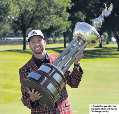  ??  ?? > Daniel Berger with the imposing Charles Schwab Challenge trophy