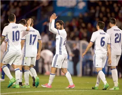  ?? — AP ?? Real Madrid playmaker Isco celebrates his goal with James Rodriguez (10), Alvaro Morata (21) and other teammates during a La Liga game against Deportivo La Coruna on Wednesday.