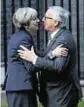  ??  ?? Sealed with a kiss for Theresa May and Jean-Claude Juncker