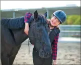  ?? PROVIDED TO CHINA DAILY ?? Zhang Jiaojiao poses with a horse at Wuhan Business University, Hubei province.