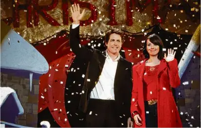  ?? PETER MOUNTAIN/UNIVERSAL STUDIOS ?? Hugh Grant and Martine McCutcheon in “Love Actually.” A one-hour special Tuesday night on ABC celebrates the movie’s 20th anniversar­y and includes interviews with the stars.