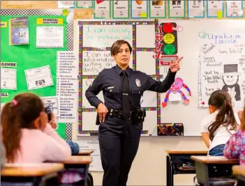  ?? PHOTO VINCENT OSUNA ?? Los Angeles Police Department Officer Brenda Quezada speaks to Mrs. Arellano’s first grade class during Career Day on Thursday at Dool Elementary School in Calexico.