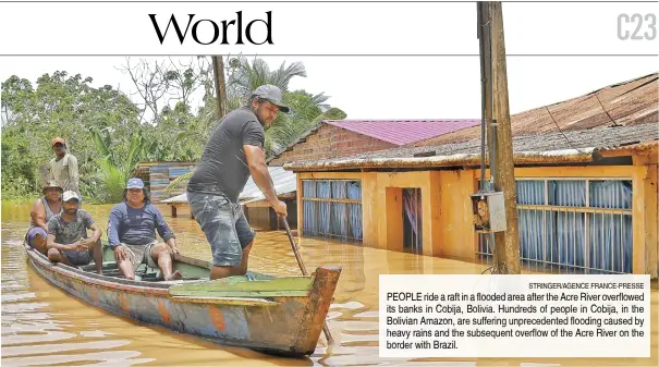  ?? STRINGER/AGENCE FRANCE-PRESSE ?? PEOPLE ride a raft in a flooded area after the Acre River overflowed its banks in Cobija, Bolivia. Hundreds of people in Cobija, in the Bolivian Amazon, are suffering unpreceden­ted flooding caused by heavy rains and the subsequent overflow of the Acre River on the border with Brazil.