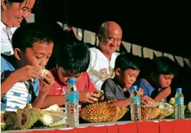  ?? CONTRIBUTE­D PHOTO ?? CHILDREN take part in a durian-eating contest in Tagum City in last year’s holding of the Durian Festival.