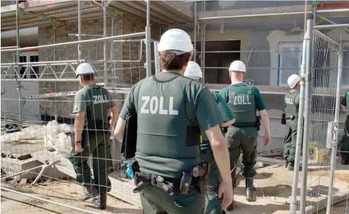  ?? Foto: dpa/Boris Roessler ?? Zollbeamte bei einer Razzia gegen Schwarzarb­eit auf einer Baustelle in Frankfurt am Main