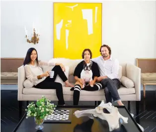  ??  ?? Pum, left, Sophie, Luna the French bulldog, and Jake Lefebure in their living room. The couple, along with their daughter, seeks refuge from the vividness of their work life in their home, which features a minimalist palette.