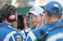 ?? AJ MAST, AP ?? Dale Earnhardt Jr., center, with his crew after dropping out of the Brickyard 400 on Sunday with radiator problems.
