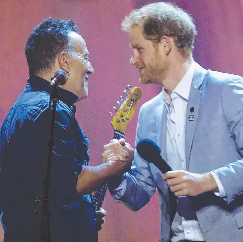  ?? Picture: AP ?? GREAT WORK: Prince Harry thanks Bruce Springstee­n for performing at the Invictus Games closing ceremony in Toronto.