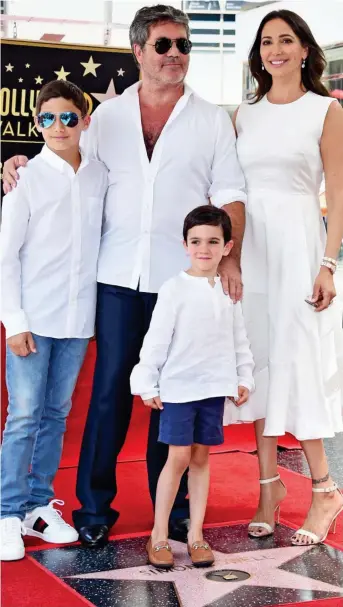  ??  ?? Team Cowell: With Lauren Silverman, their son Eric, front, and her son Adam