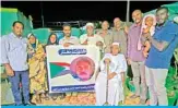  ??  ?? The family of Mukhtar Abdallah poses for a picture with a banner bearing his portrait in Atbara city, on the banks of the River Nile, northeast of Sudan’s capital Khartoum on Dec 15, 2019. — AFP