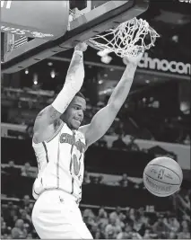  ?? [JASON E. MICZEK/THE ASSOCIATED PRESS] ?? Charlotte’s Miles Bridges dunks during Saturday’s game against Boston.