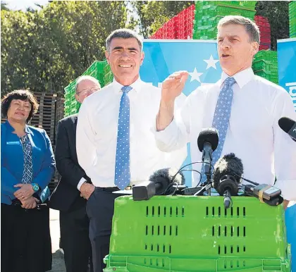  ?? Picture / Mark Mitchell ?? Bill English, pictured with Primary Industries Minister Nathan Guy, has kept up a concerted attack on Labour over the lack of detail on its tax policy.