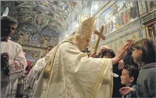  ?? TRADITIONA­LIST L’Osservator­e Romano ?? Benedict baptizes a child in the Sistine Chapel in 2012. In office, he focused on trying to shore up Christiani­ty in his native Europe, but church attendance on the continent continued to decline.