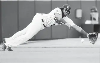  ?? NATHAN DENETTE THE CANADIAN PRESS ?? Bisons third baseman Vladimir Guerrero Jr. dives for the ball but can’t make the catch on a single by Lehigh Valley IronPigs right-fielder Aaron Altherr during first-inning triple-A baseball action in Buffalo on Tuesday.