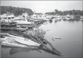  ?? Joe Ahlquist/The Rochester Post-Bulletin via AP ?? Storm Damage: A boat damaged by a fallen tree sits in the Ole Miss Marina Tuesday, after Monday night's storm in Vasa, Minn.