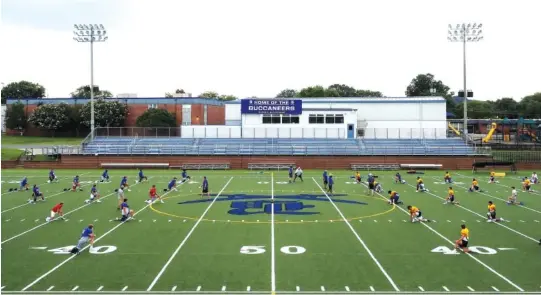  ?? STAFF PHOTO BY C.B. SCHMELTER ?? Boyd Buchanan players warm up before practice at David L. Boyd Field on Monday.