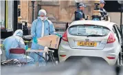  ?? [AP PHOTO] ?? Forensics officers work near the car that crashed into security barriers outside the Houses of Parliament on Tuesday in London.