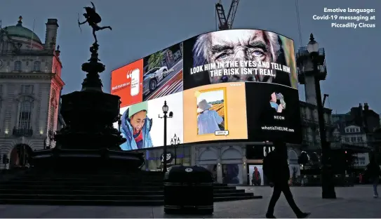  ??  ?? Emotive language: Covid-19 messaging at Piccadilly Circus