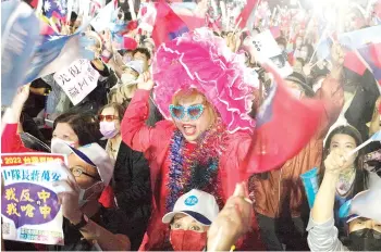  ?? —AFP photo ?? Supporters of the main opposition Kuomintang (KMT) and candidate Chiang Wan-an (not pictured) attend a mayoral election campaign rally in Taipei.