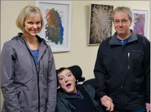  ?? NEWS PHOTO CHRIS BROWN ?? Rylan Stein and his parents pose in front of some of his paintings at the Medicine Hat Public Library on Friday.