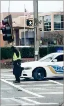  ?? Facebook ?? Rome Police Officer Kevin Drew, amid the drizzle on a windy Sunday morning, went above and beyond to help motorists navigate a fallen traffic signal.