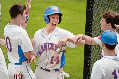  ?? TIM COOK/THE DAY ?? In this June 1, 2019, file photo, Waterford’s Connor Podeszwa (14) celebrates as he heads back to the dugout after scoring the first run of the game in the CIAC Class L baseball tournament quarterfin­al against Law at Waterford High School.