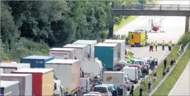  ??  ?? ANXIOUS WAIT: Police closed the M20 while an air ambulance landed