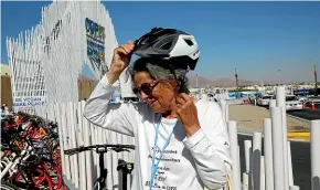  ?? AP ?? Dorothee Hildebrand­t, 72, removes her bike helmet after arriving at the UN climate summit COP27 venue in Sharm el-sheikh, Egypt.